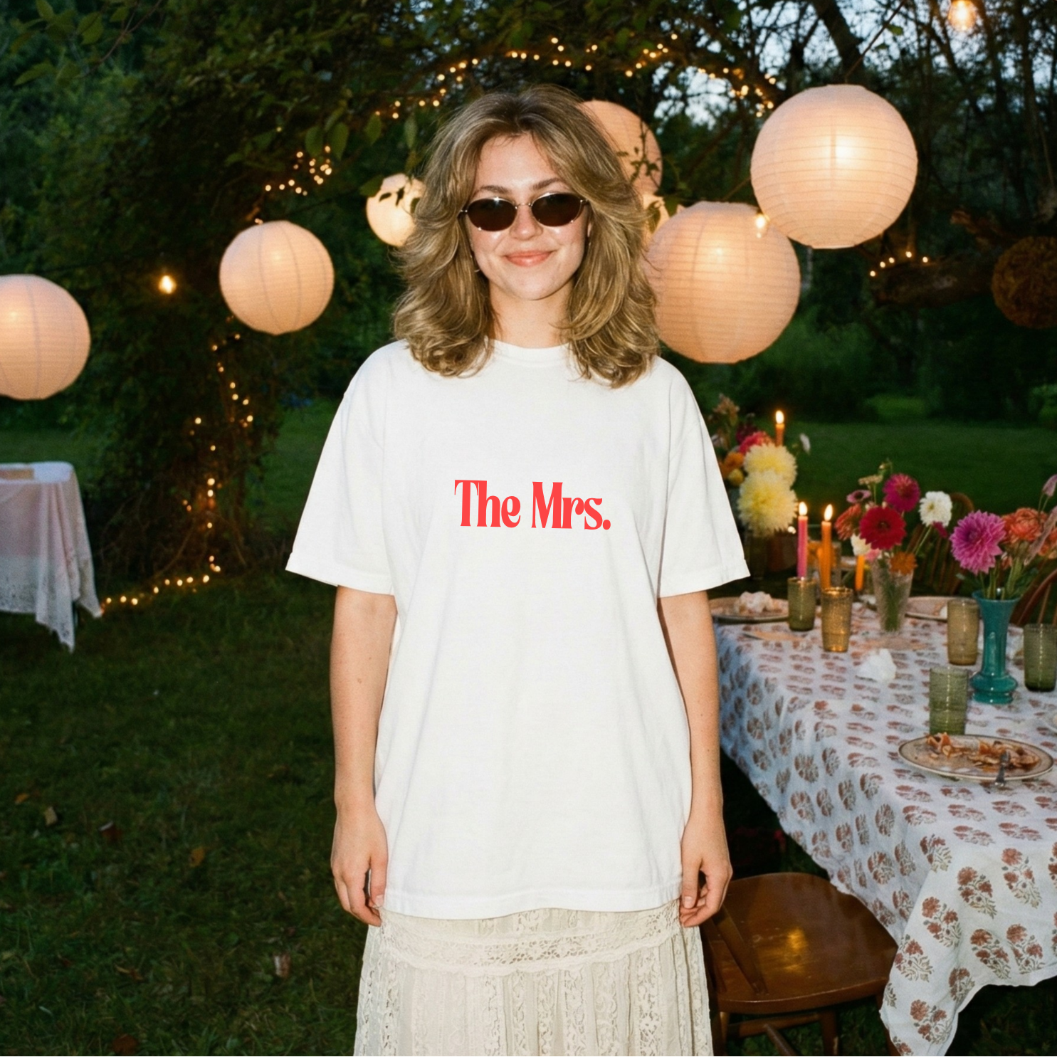 Woman wearing a white t-shirt with 'The Mrs.' text against a hen party background